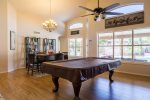 Open family room w/ large HDTV, billiards table, and extra dining space
